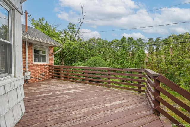 a view of a roof deck with wooden floor and fence