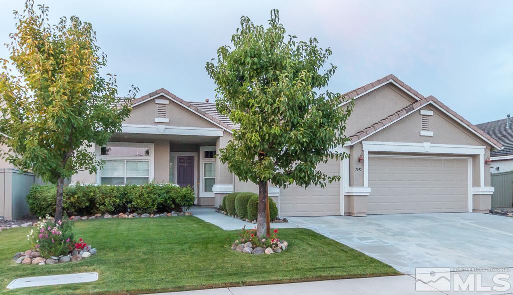 1645 Ghettis Way Reno, NV 89521 - Photo 1 of 1 a front view of a house with a yard and garage