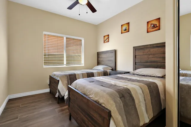 a bedroom with two beds and a window