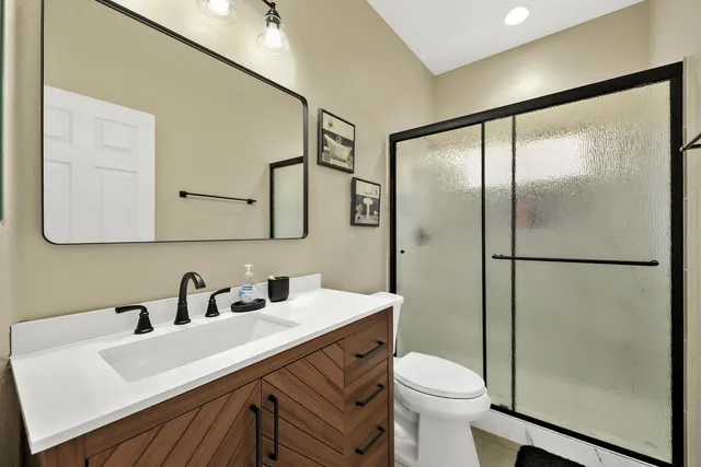 a bathroom with a sink toilet and shower