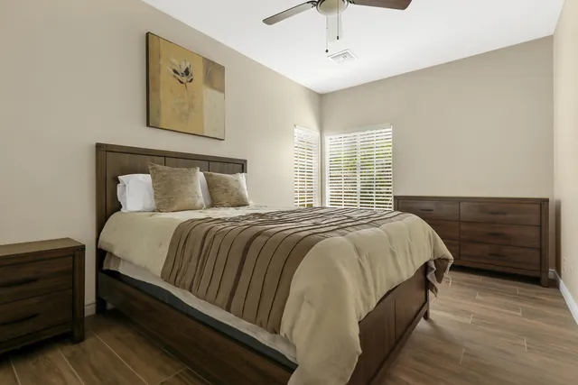 a bedroom with a bed and wooden floor