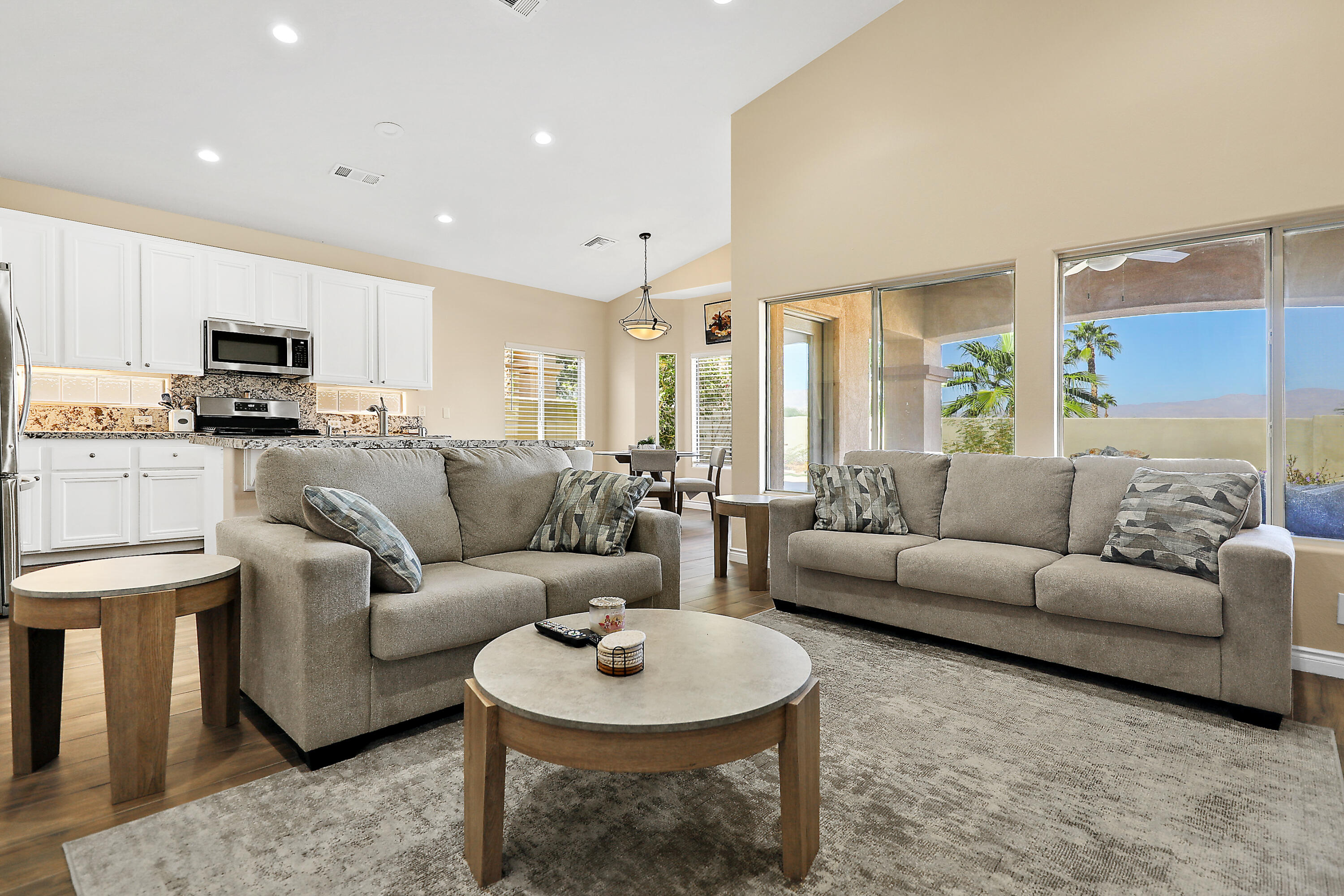 79948 Bethpage Avenue Indio, CA 92201 - Photo 5 of 30 a living room with furniture a rug kitchen view and a window