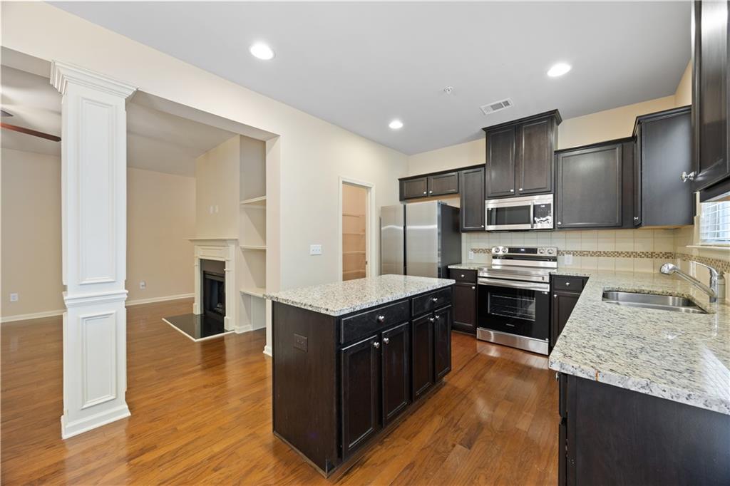 2296 Thackery Road Southwest Snellville, GA 30078 - Photo 11 of 26 a kitchen with stainless steel appliances granite countertop a stove top oven a sink and a granite counter tops