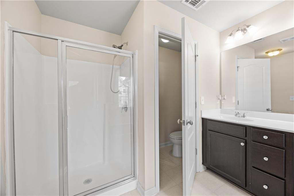 2296 Thackery Road Southwest Snellville, GA 30078 - Photo 18 of 26 a bathroom with a double vanity sink and mirror