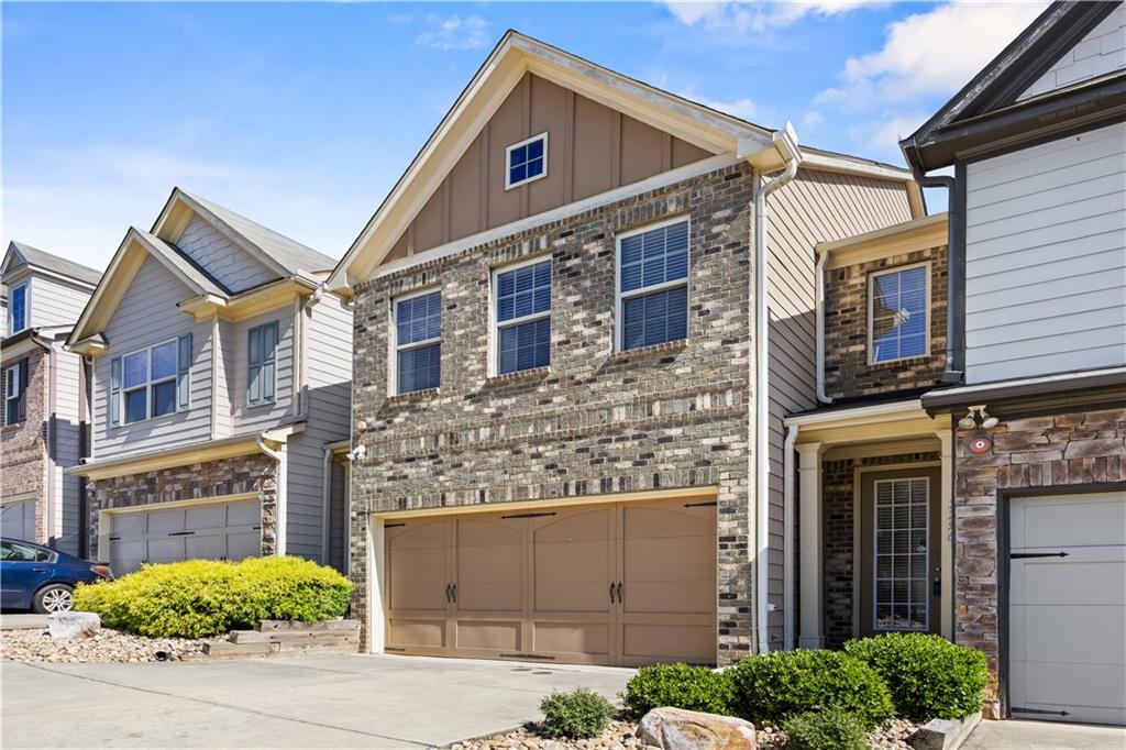 2296 Thackery Road Southwest Snellville, GA 30078 - Photo 2 of 26 a front view of a building with a garden and plants