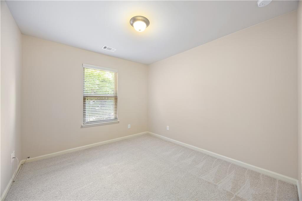 2296 Thackery Road Southwest Snellville, GA 30078 - Photo 21 of 26 an empty room with a window