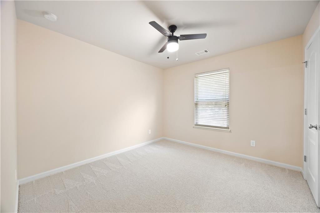 2296 Thackery Road Southwest Snellville, GA 30078 - Photo 22 of 26 an empty room with a window and a fan