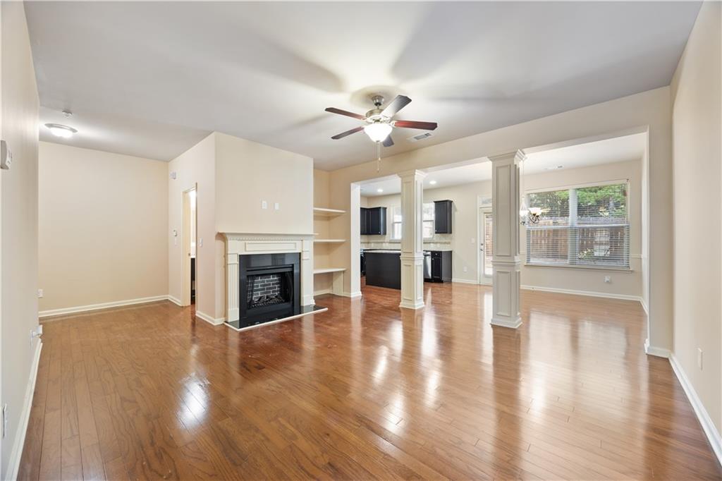 2296 Thackery Road Southwest Snellville, GA 30078 - Photo 5 of 26 a view of empty room with wooden floor and fireplace