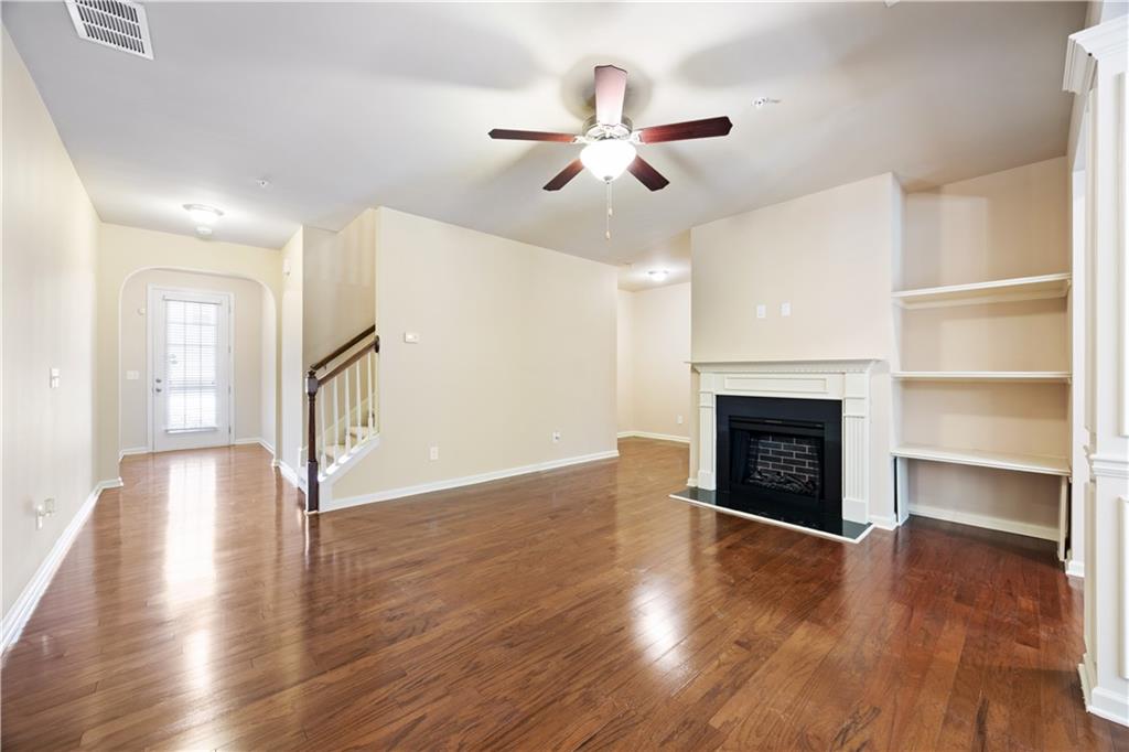 2296 Thackery Road Southwest Snellville, GA 30078 - Photo 6 of 26 a view of an empty room with wooden floor fireplace and a window
