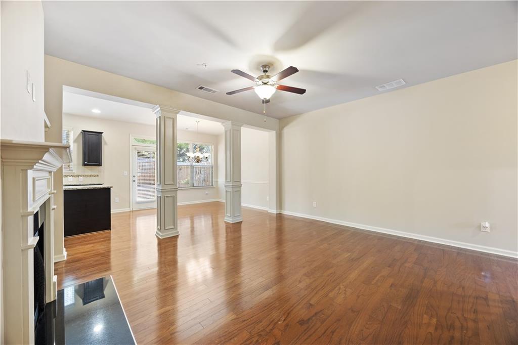 2296 Thackery Road Southwest Snellville, GA 30078 - Photo 7 of 26 a view of an empty room with wooden floor and a fireplace