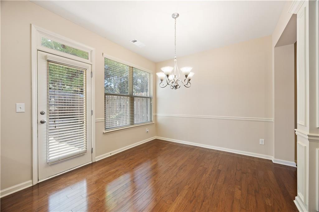 2296 Thackery Road Southwest Snellville, GA 30078 - Photo 8 of 26 a view of a room with wooden floor and a window