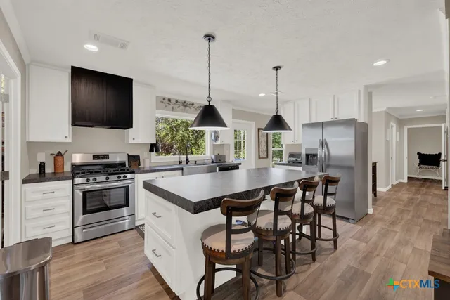 a bedroom with furniture and a flat screen tv