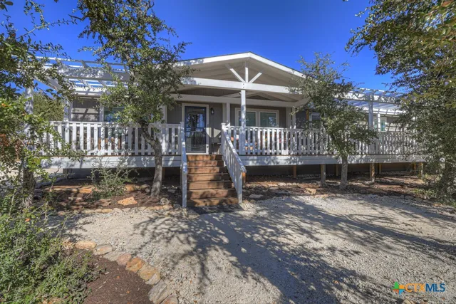 a living room with furniture a flat screen tv and a large window