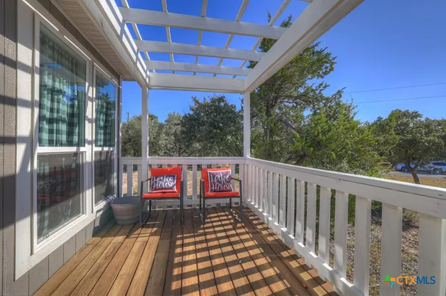 a view of a workspace with furniture and window
