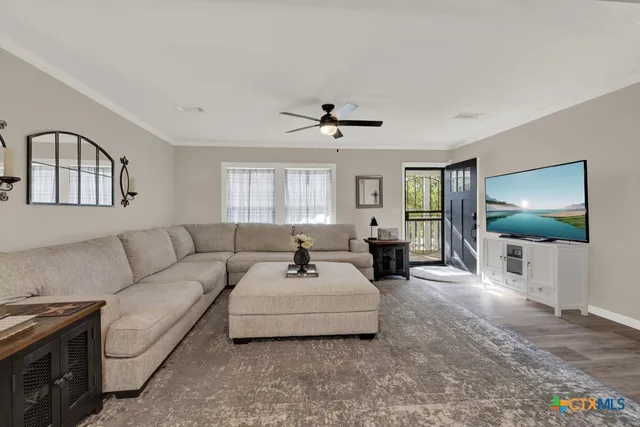 a bedroom with a large bed and a flat tv screen on dresser