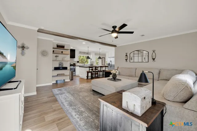 a front view of a house with a yard and potted plants