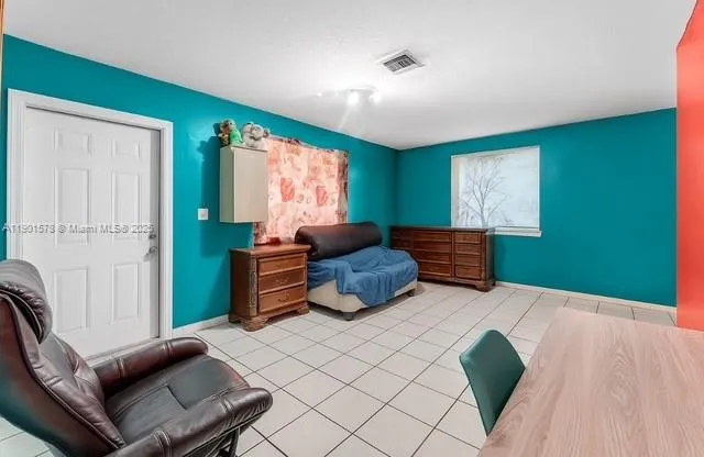 a kitchen with granite countertop a refrigerator and a stove top oven