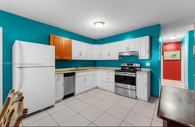 313 Northwest 12th Street Homestead, FL 33030 - Photo 6 of 16 a kitchen with granite countertop a refrigerator and a stove top oven