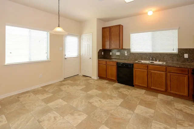 a large kitchen with kitchen island granite countertop a sink and a stove