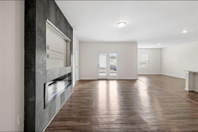 a view of a livingroom with wooden floor and staircase