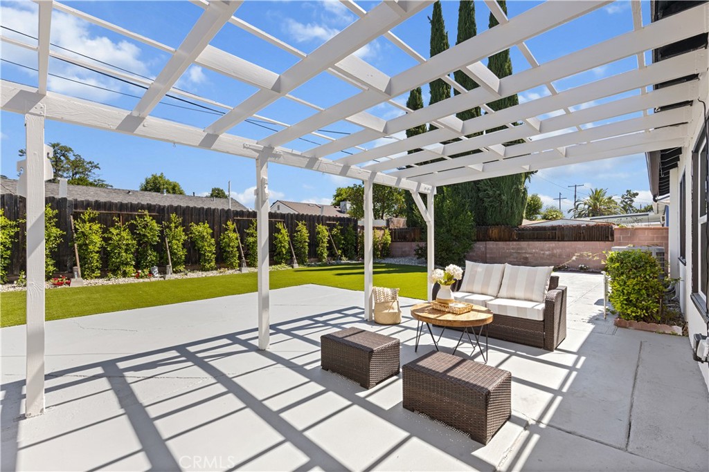 17801 Lanark Street Reseda, CA 91335 - Photo 13 of 17 a view of a patio with a table and chairs under an umbrella with a big yard