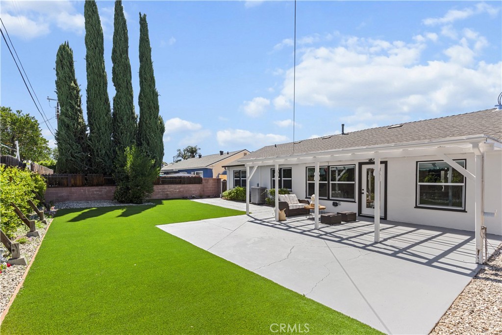 17801 Lanark Street Reseda, CA 91335 - Photo 14 of 17 a patio with a table and chairs and potted plants