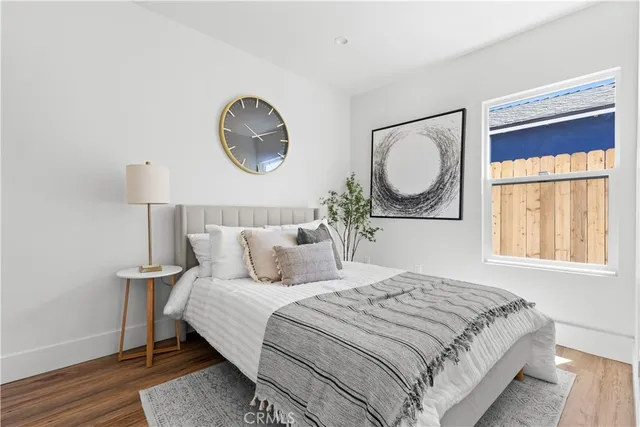 a bedroom with a bed and a painting on the wall