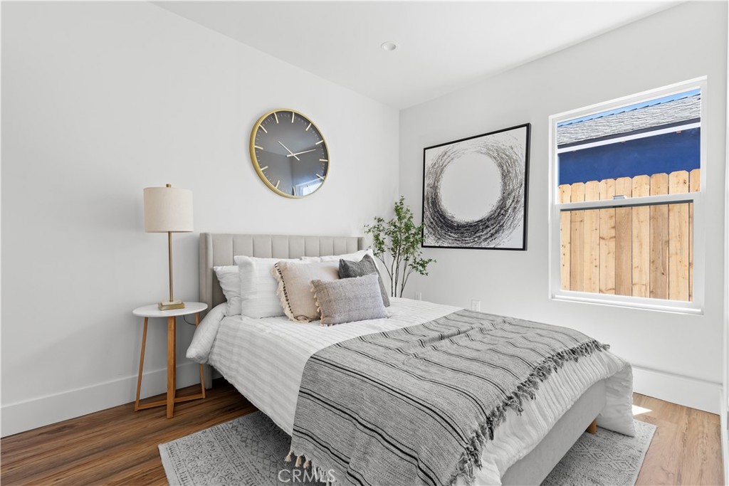 17801 Lanark Street Reseda, CA 91335 - Photo 16 of 17 a bedroom with a bed and a painting on the wall