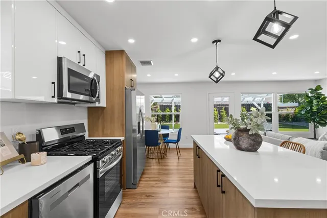 a kitchen with sink a stove and cabinets