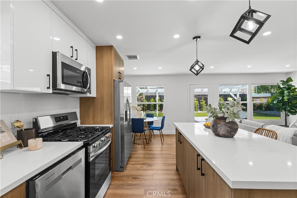 17801 Lanark Street Reseda, CA 91335 - Photo 3 of 17 a kitchen with sink a stove and cabinets