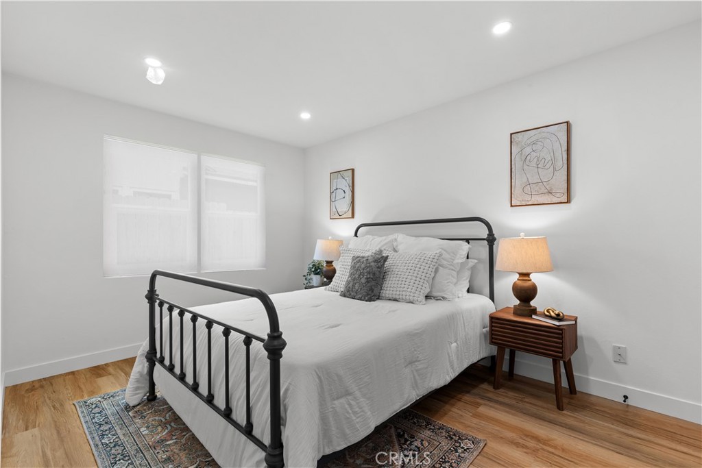 17801 Lanark Street Reseda, CA 91335 - Photo 6 of 17 a bedroom with a bed and wooden floor