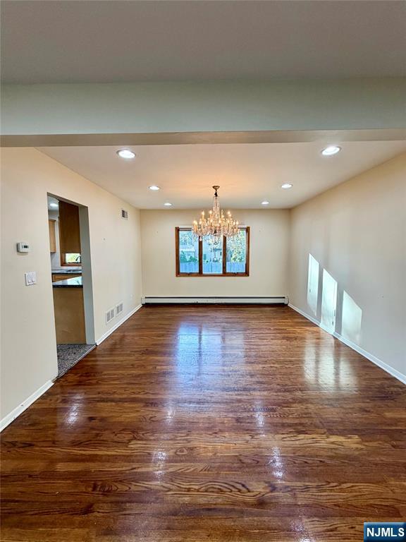 517 Fordham Place Paramus, NJ 07652 - Photo 5 of 25 a view of empty room with wooden floor and kitchen