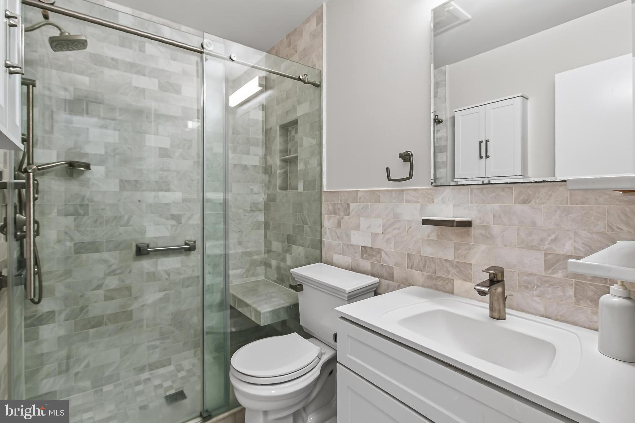 7604 Boulder Street Springfield, VA 22151 - Photo 9 of 39 a bathroom with a sink a toilet and shower