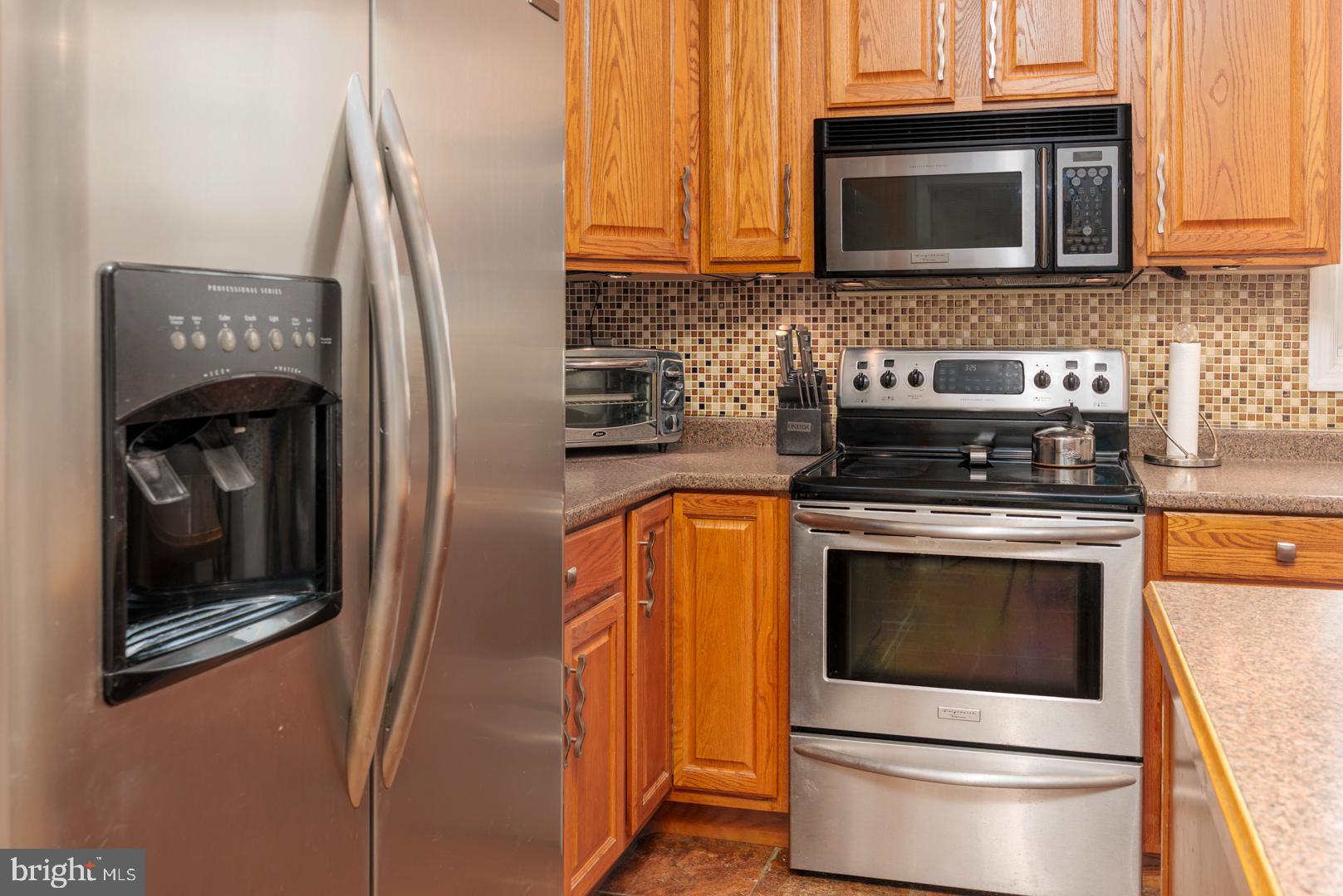 4904 Ravenwood Road Vienna, MD 21869 - Photo 12 of 42 a kitchen with a stove microwave and sink