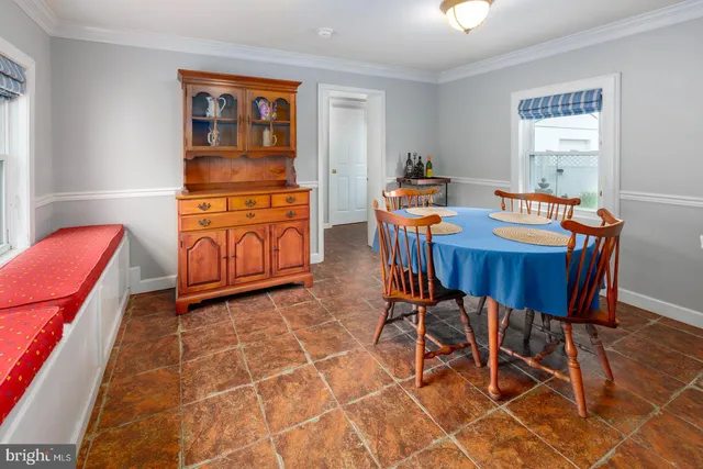 a dining room with furniture and window
