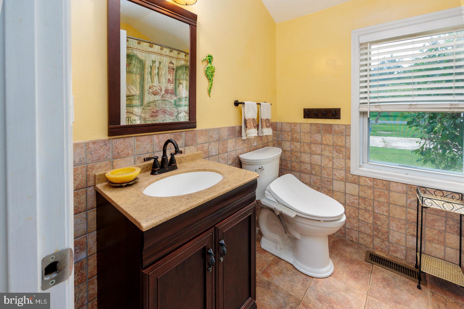 4904 Ravenwood Road Vienna, MD 21869 - Photo 17 of 42 a bathroom with a sink and a toilet