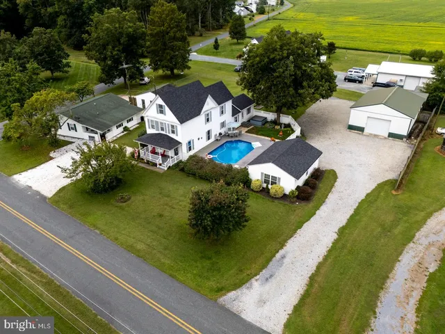 an aerial view of a house with a garden and swimming pool