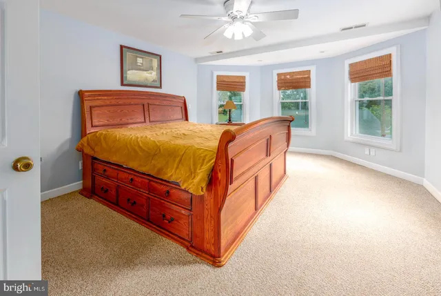 a bed sitting in a bedroom next to a window
