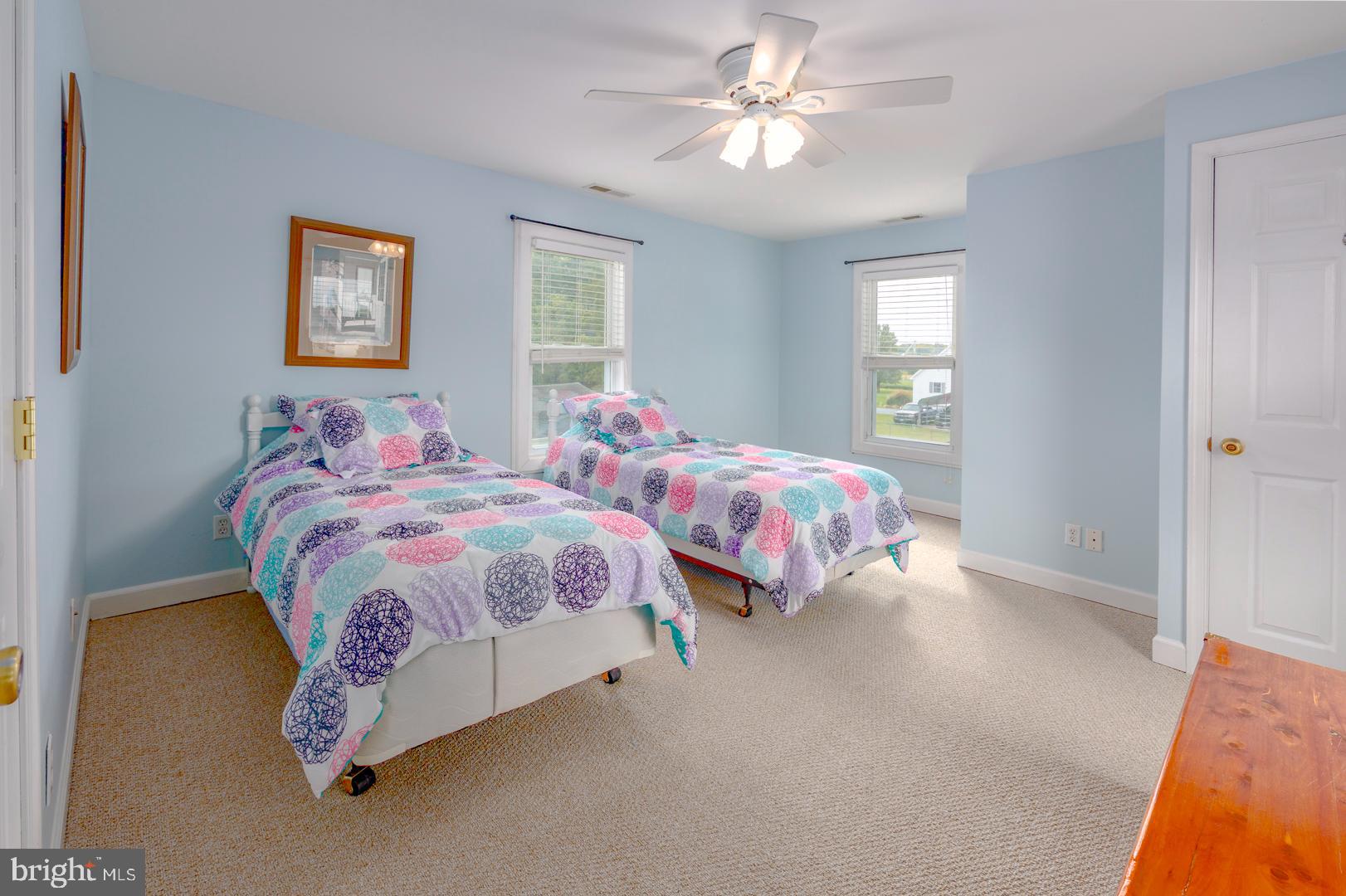 4904 Ravenwood Road Vienna, MD 21869 - Photo 25 of 42 a bedroom with two beds and a chandelier