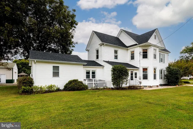 an aerial view of a house with a garden and swimming pool