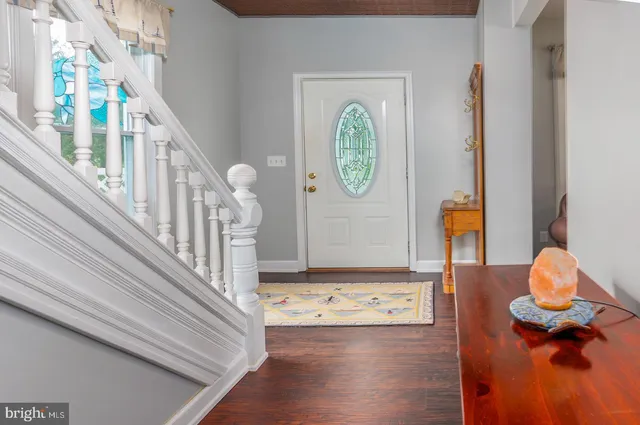 a view of entryway and hall with wooden floor
