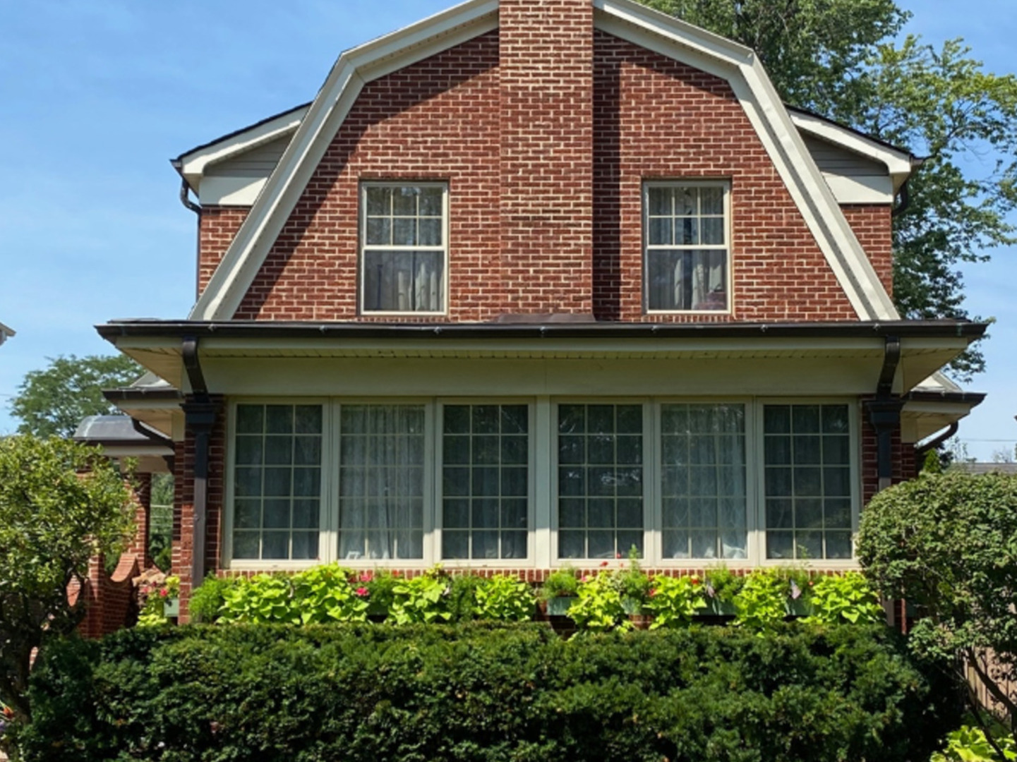 a front view of a house with a garden