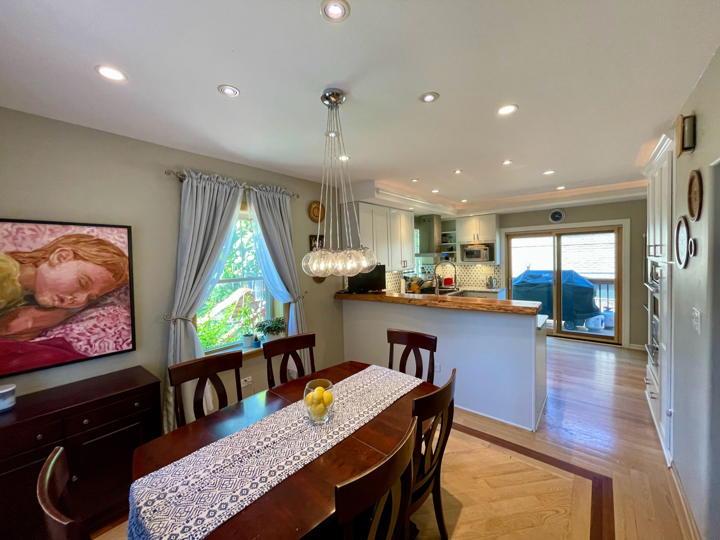 420 North Washington Avenue Park Ridge, IL 60068 - Photo 7 of 36 a kitchen with stainless steel appliances granite countertop a refrigerator a sink a stove a dining table and chairs with wooden floor