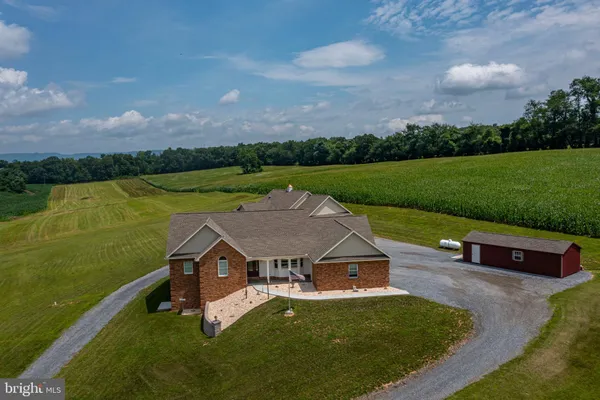 an aerial view of a golf course with a lake view