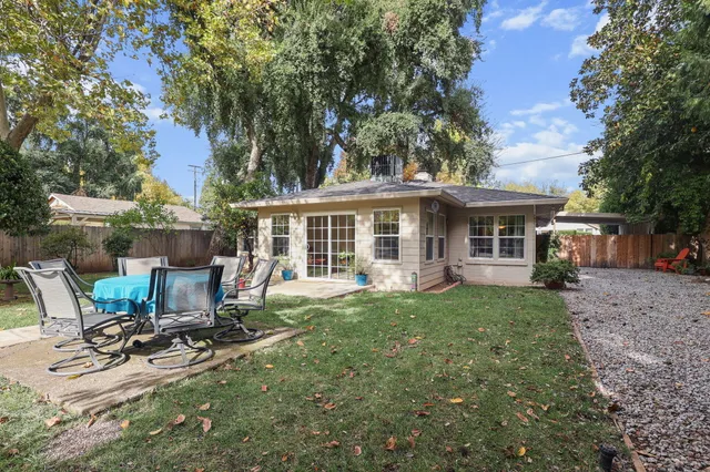 a view of a house with backyard sitting area and garden
