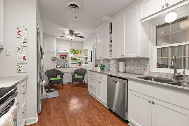 a kitchen with cabinets a sink and appliances