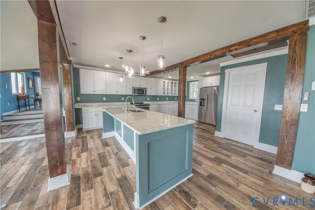 a kitchen with kitchen island a sink stove and refrigerator