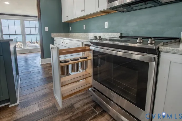 a stove top oven sitting inside of a kitchen