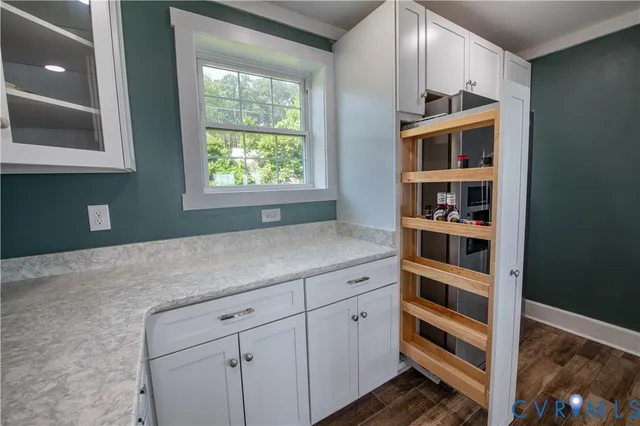 a kitchen with cabinets and window