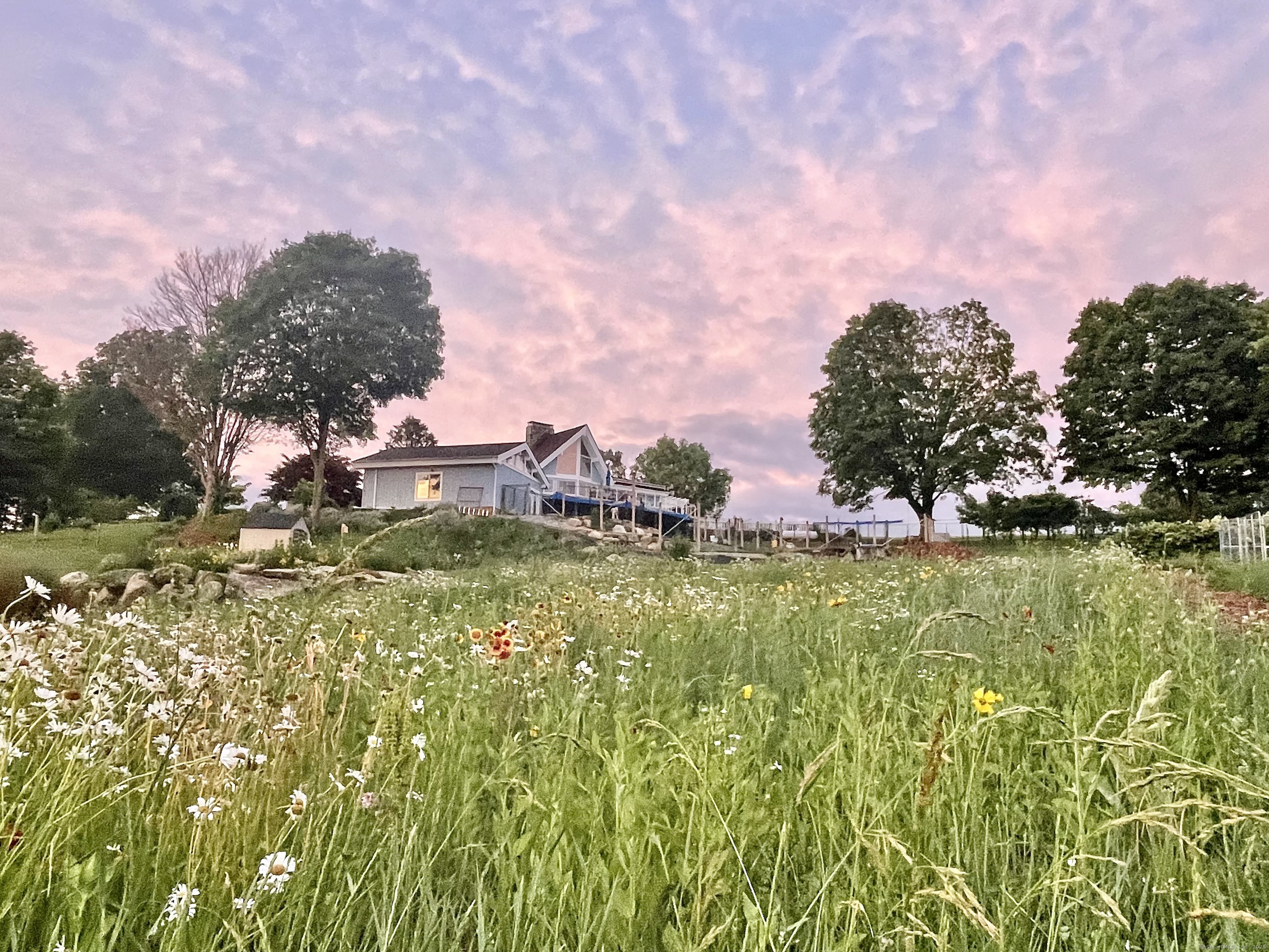 a swimming pool with trees in the background